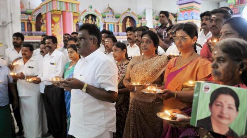 AIADMK MLA Amman Arjunan along with party members offering prayers for the recovery of Tamil Nadu CM Jayalalithaa, in Coimbatore on Saturday. (Photo: PTI)