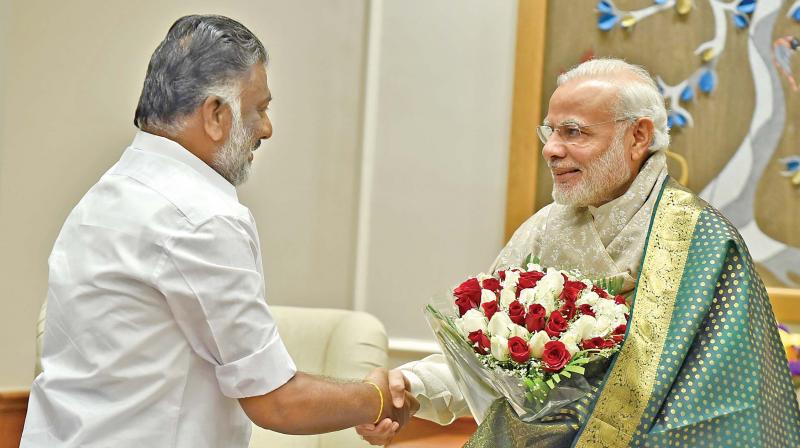 Chief Minister O. Panneerselvam greets Prime Minister Narendra Modi in Delhi during his visit on Monday.