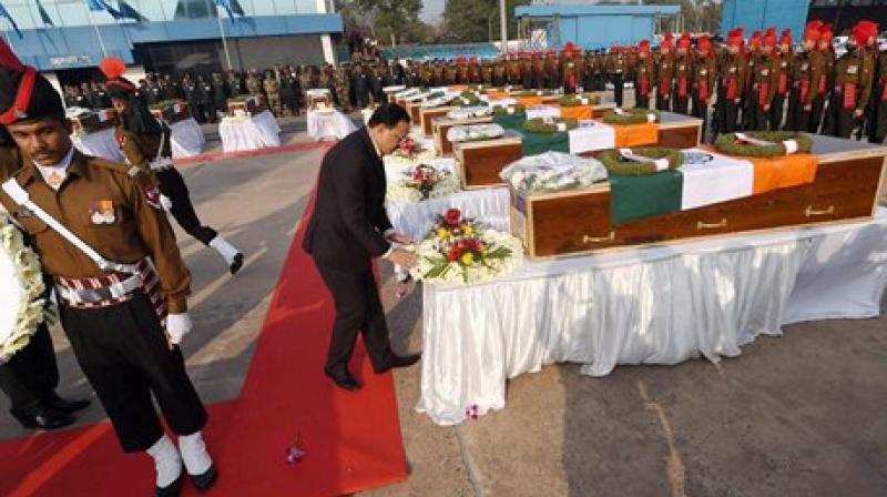 MoS for Defence Subhash R Bhamre paying homage at the coffins of their colleagues killed in the recent avalanches in Gurez Sector, after they were flown to AFS Palam in New Delhi from J & K. (Photo: AP)