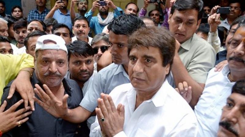 Congress leader Raj Babbar meets the family members of jewellers who were killed during a robbery incident in Mathura on Thursday. (Photo: PTI)