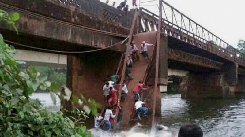 Around 50 people had gathered on the bridge to watch the rescue efforts when it gave way and they plunged into the water. (Photo: PTI)