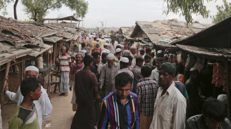 In this Dec. 2, 2016, file photo, Rohingya from Myanmar make their way in an alley at an unregistered refugee camp in Teknaf, near Coxs Bazar. (Photo: AP)