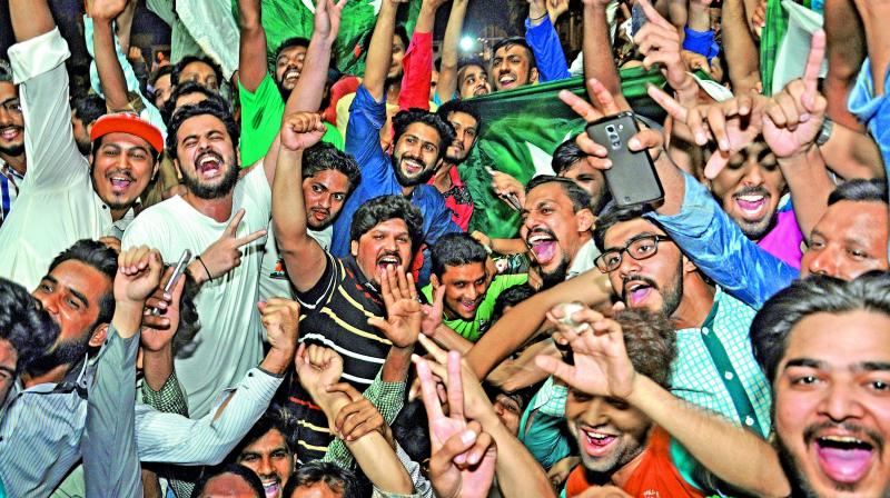 Pakistan fans celebrate their teams triumph over India in the final of the ICC Champions Trophy on Sunday (Photo: AP)