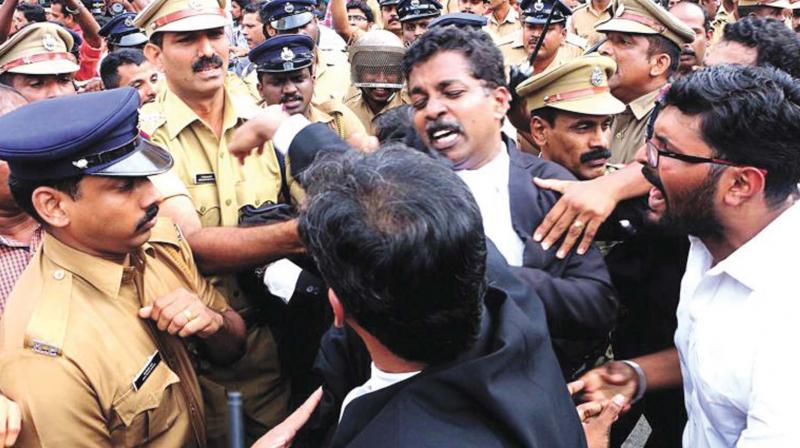 A group of advocates trying to break a police cordon near the Kerala High Court during tussle with media persons. DC FILE