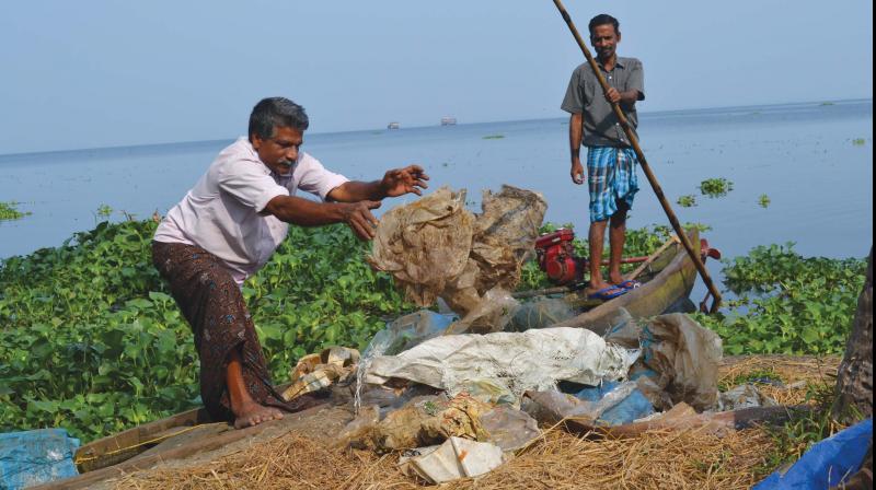 Fishermen collect plastic waste from lake 	 DC File