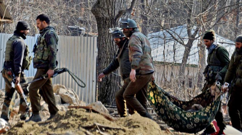 Special Operation Group of J&K police carrying the body of a militant that was recovered from the rubbles of destroyed house where militants were hiding during an encounter in Kulgam. (Photo: PTI)