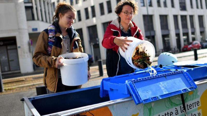 Members of La Tricyclerie association collect organic wastes from restaurants and companies to supply a compost in Nantes, western France, on Sept 11, 2017. (Photo: AFP)