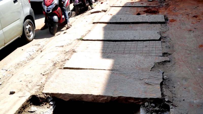 The poor condition of a footpath on NH 209 with a missing drain cover that poses life threat to pedestrians. (Photo: DC)