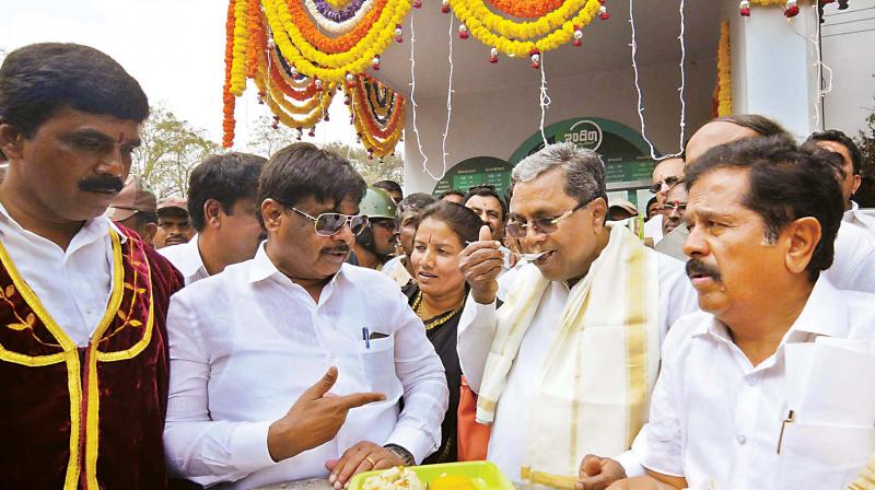 Chief Minister Siddaramaiah and Public Works Minister H.C. Mahadevappa at the launch of Indira Canteen in Mysuru on Friday. (Photo: KPN)