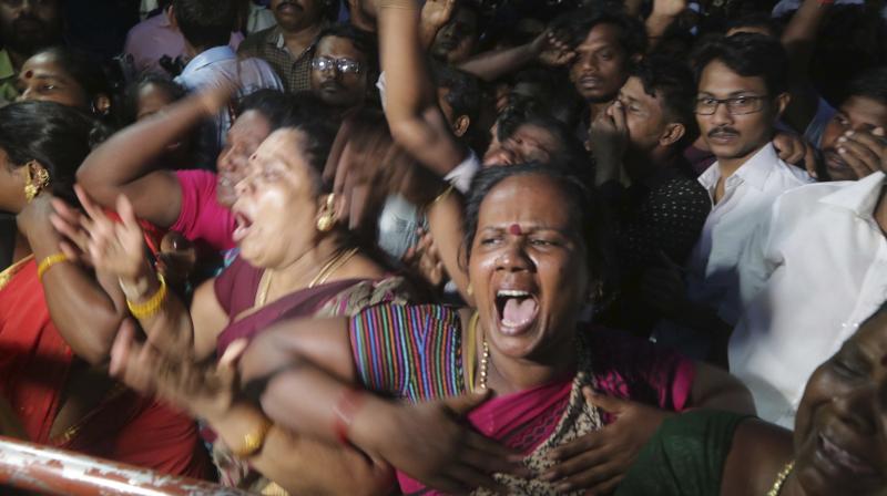 Supporters of former Tamil Nadu chief Minister and Dravida Munnetra Kazhagam political party chief Muthuvel Karunanidhi wail upon hearing the news of his demise outside the Kauvery Hospital in Chennai on Tuesday. (Photo: AP)
