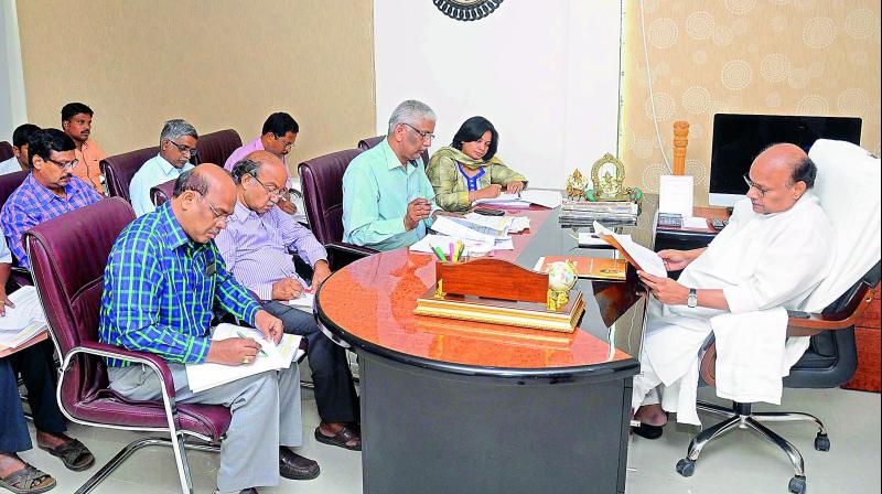 Finance minister Yanamala Ramakrishnudu holds a meeting with officials in Velagapudi temporary Secretariat on Wednesday. 	(Photo  DC)