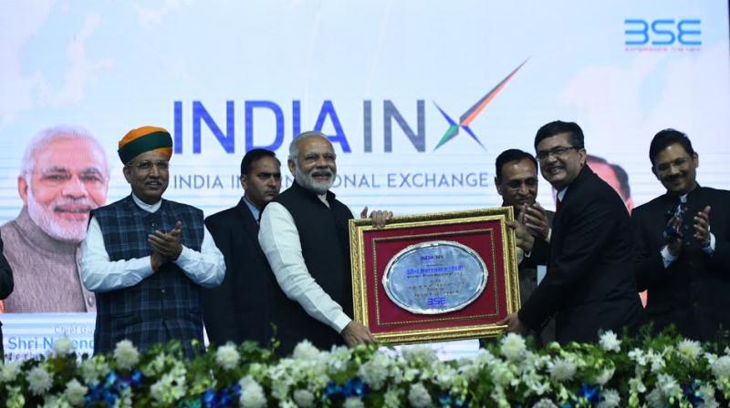 Narendra Modi being presented a memento at the inauguration ceremony of India International Exchange in GIFT City. (Photo: Twitter/PIB)
