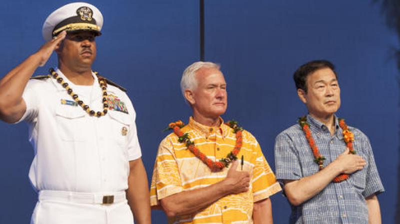 File photo of US Navy Read Adm John Fuller (left), Honolulu Mayor Kirk Caldwell (center) and the previous Nagaoka City Mayor Tomio Mori look on during a celebration marking the 70th anniversary of the end of World War II at Joint Base Pearl Harbor-Hickam, in Honolulu.
