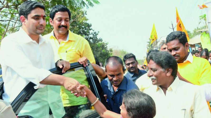 Minister for IT Nara Lokesh greets people in Gannavaram constituency in Guntur district on Thursday. and girl at the development programmes at Gannavaram constituency in Krishna district on Thursday, MLA V Vamshimohan is also seen.