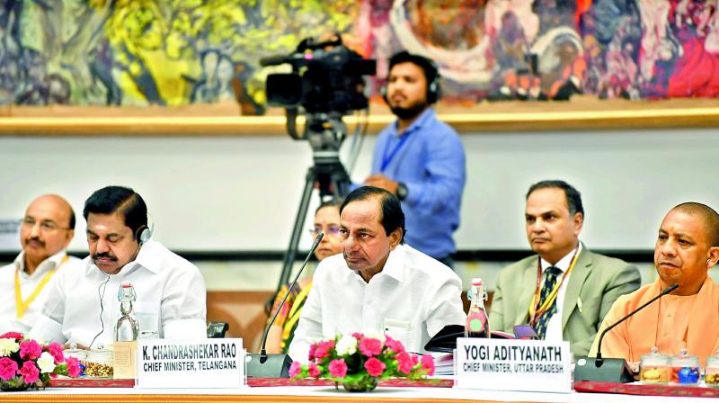 TS Chief Ministers K. Chandrasekhar Rao with UP CM Yogi Adityanath at the Niti Aayog meet on Sunday.