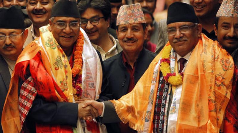 Nepals newly elected prime minister Sher Bahadur Deuba, left, poses with his predecessor Pushpa Kamal Dahal at the Parliament House in Kathmandu, Nepal. (Photo: AP)