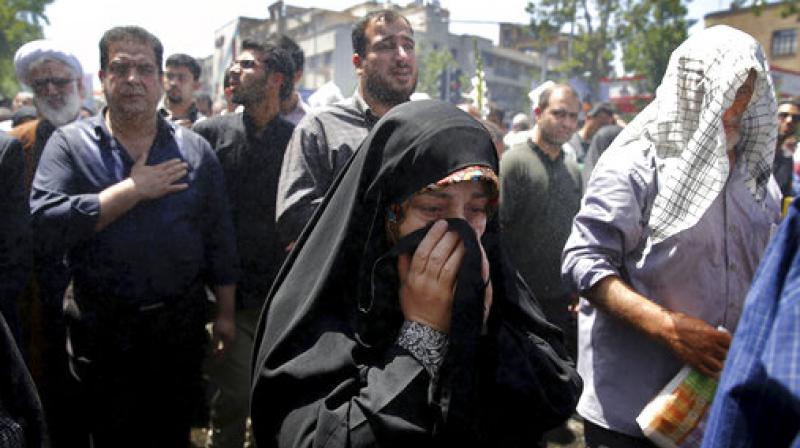 Iranians attend the funeral of victims of an Islamic State militant attack on Wednesday, in Tehran, Iran. (Photo: AP)