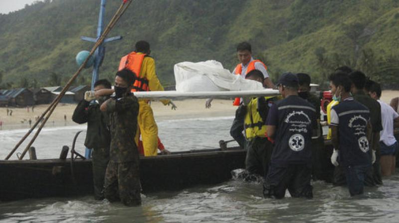 Rescue personnel carry bodies recovered by fishing vessels in the waters off San Hlan village, in Laung Lone township, southern Myanmar. Fishermen have joined navy and air force personnel in recovering bodies and aircraft parts from the sea off Myanmar, where a military plane carrying 122 people including 15 children crashed a day earlier. (Photo: AP)