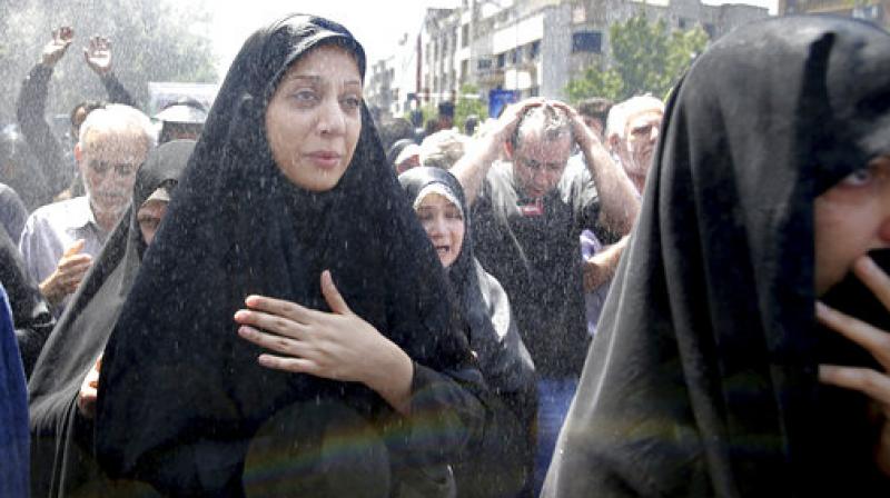 ranians attend the funeral of victims of an Islamic State militant attack on Wednesday, in Tehran, Iran. (Photo: AP)