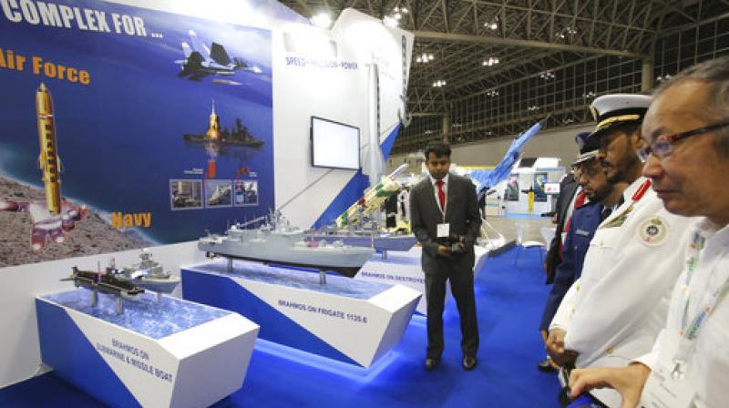 Visitors look at the booth of BrahMos, the India-Russia joint venture, during \ MAST Asia\, Japans international arms exhibit, supported by Japanese government, in Chiba, near Tokyo. The three-day exhibit, second since Japans 2014 easing of arms export rules, began Monday near Tokyo. (Photo: AP)