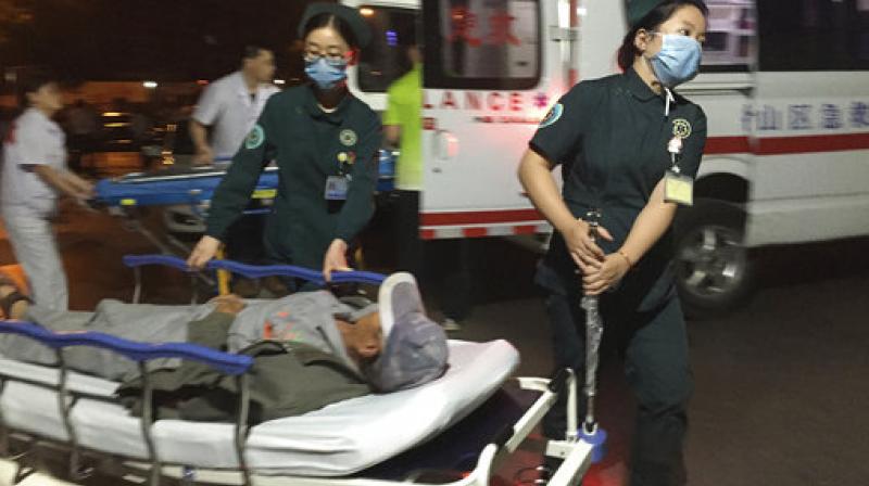 In this photo released by Chinas Xinhua News Agency, medical workers transport a person injured in an explosion outside a kindergarten into a hospital in Fengxian County in eastern Chinas Jiangsu Province early. (Photo: AP)