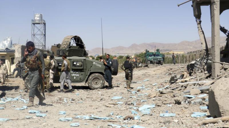 Security forces are deployed at the site of suicide attacks and an ongoing clash between Taliban insurgents and government forces in the main police station in eastern Paktia province, Afghanistan. (Photo: AP)