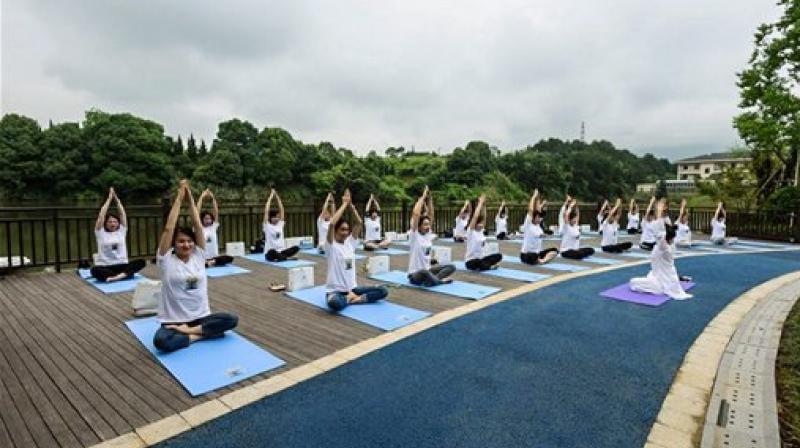 Over thousand people from Chinas Tonglus city practiced Yoga at the Jiangnan Lakeside Healing Resort on Saturday ahead of 3rd International Day Yoga Celebrations, (IDYC). (Photo: AP)