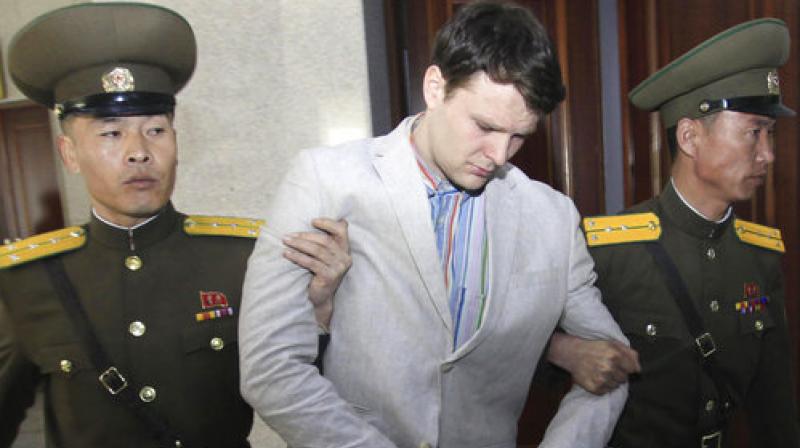 American student Otto Warmbier, center, is escorted at the Supreme Court in Pyongyang, North Korea. Warmbier, an American college student who was released by North Korea in a coma last week after almost a year and a half in captivity, died Monday. (Photo: AP)