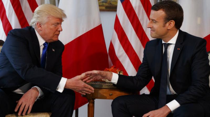 US President Donald Trump, shaking hands with French President, Emmanuel Macron, during a meeting at the US Embassy in Brussels. (Photo: AP)