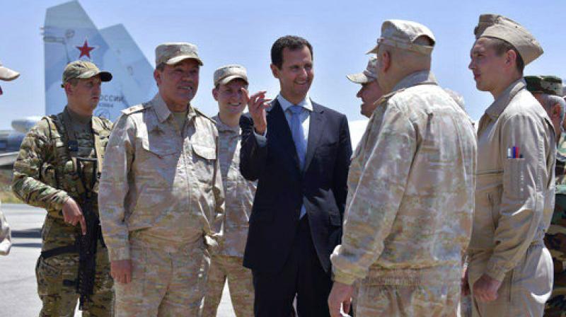 Syrian President Bashar Assad inspects with the Russian Armys Chief of Staff, Gen. Valery Gerasimov, the Russian Hmeimim air base in the province of Latakia, Syria. (Photo: AP)