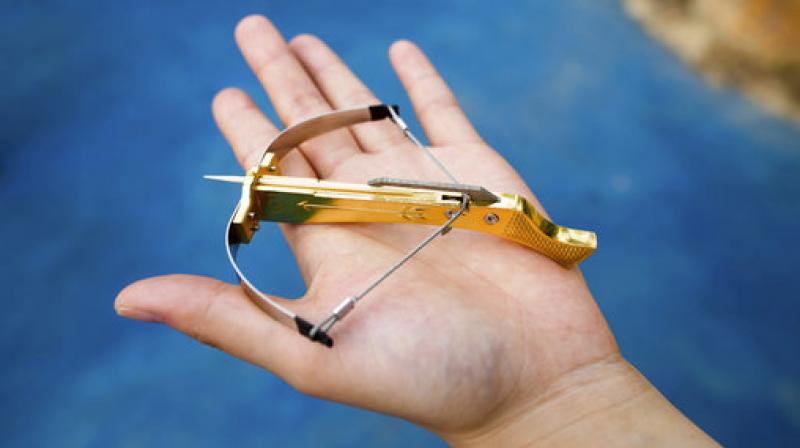 A boy displays a toothpick crossbow in Yangzhou in eastern Chinas Jiangsu Province Saturday. (Photo: AP)