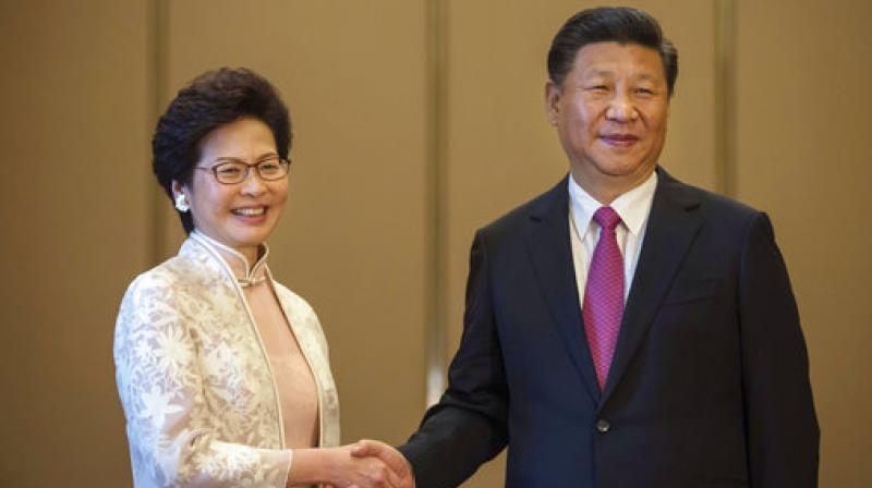 Chinese President Xi Jinping poses with Hong Kongs Chief Executive Carrie Lam ahead of a meeting in Hong Kong. (Photo: AP)