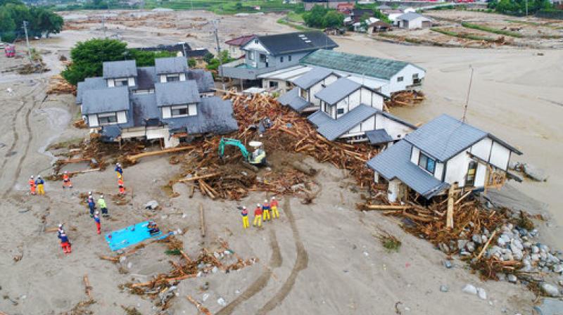 Firefighters inspect the collapsed houses in the mud following the flooding caused by heavy rain in Asakura, Fukuoka prefecture, southwestern Japan. (Photo: AP)