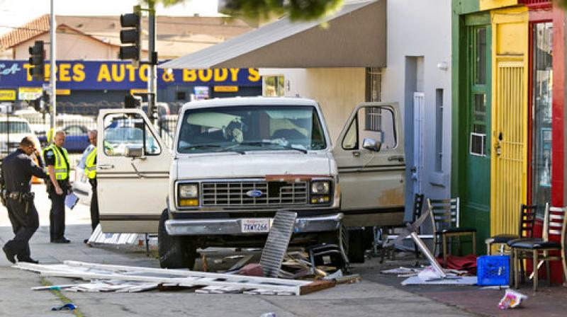 An official looks at a van that plowed into a group of people on a Los Angeles sidewalk. A witness to the crash told The Associated Press the van jumped a curb and careened into a group of people eating outside The Fish Spot restaurant in the citys Mid-Wilshire neighborhood. The cause of the crash is under investigation. (Photo: AP)