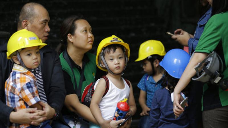 Children wear helmets as they evacuate a building after an earthquake was felt in Manila, Philippines. (Photo: AP)