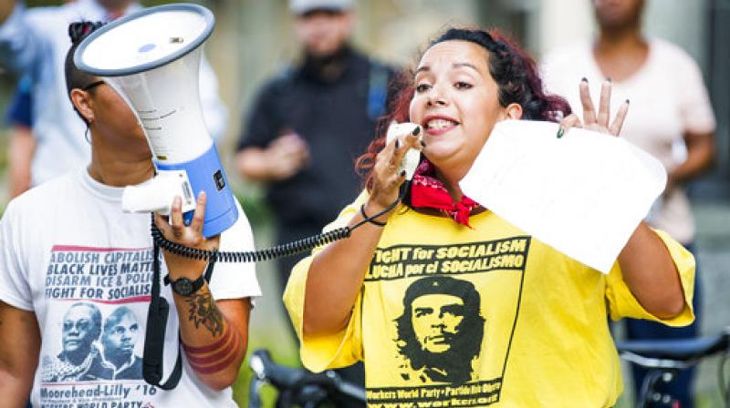 Alissa Ellis speaks to a crowd of protesters gathered in front of a Confederate statue at the old Durham County Courthouse, Monday, Aug. 14, 2017, in Durham, N.C. Protesters in North Carolina toppled a nearly century-old statue of a Confederate soldier Monday at the rally against racism. (Photo: AP)