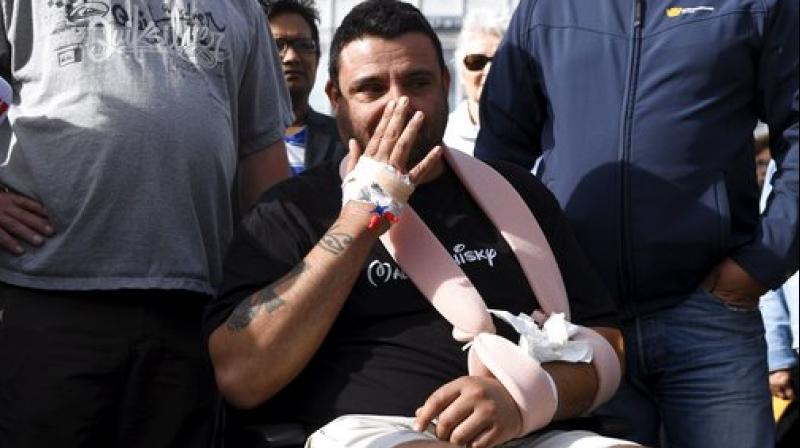 Hassan Zubier wipes his face as he visits Turku Market Square in Turku, Finland. Zubier was injured in the mass stabbing in Turku on Friday Aug. 18 as he attempted to help a stabbing victim. The knife attack in western Finland that left two people dead and several wounded is \a likely terror act,\ Finlands intelligence agency said Saturday, while police said Europol was investigating if it had any ties to deadly vehicle attacks in Spain. (Photo: AP)