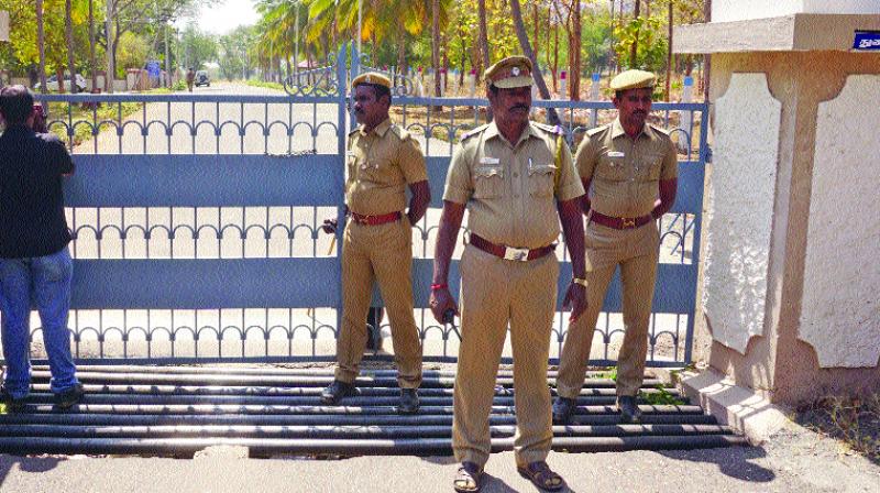 Police force deployed in front of the Bharathiar University VCs bungalow in Coimbatore on Saturday during the raid by DVAC sleuths. (Photo: DC)