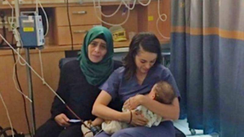 Nurse Ula Ostrowski-Zak with baby Yaman Abu Ramila. (Hadassah International Facebook)