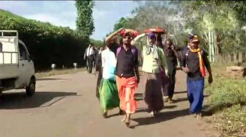 Devotees were seen trekking up the hill while chanting hymns in praise of the deity. (Photo: ANI)