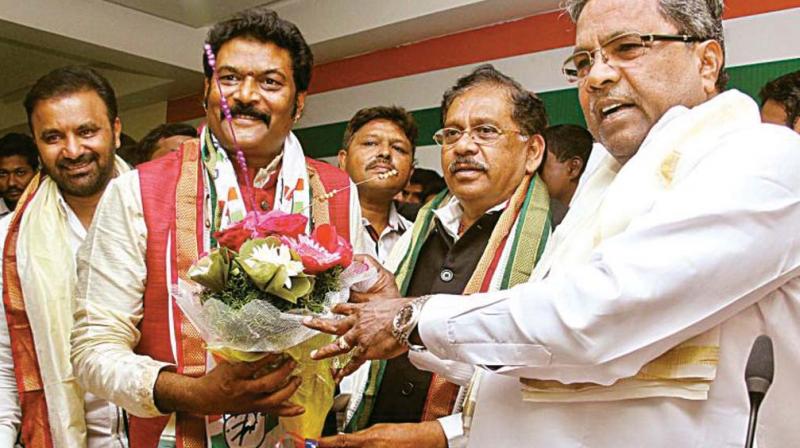 Hosapete MLA Anand Singh is greeted by Chief Minister Siddaramaiah and KPCC chief Dr G. Parameshwar after he joined the Congress in Bengaluru a few days ago
