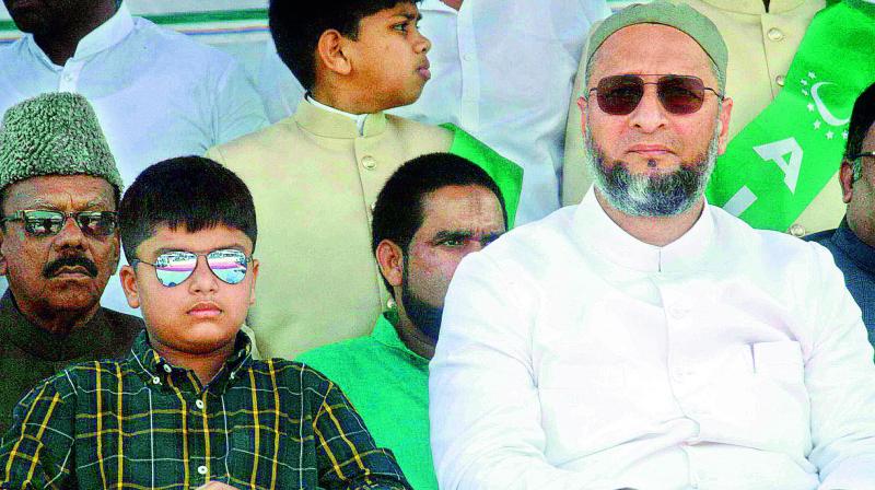 MIM president Asaduddin Owaisi and his son Salahuddin watch the 61st revival day celebrations of the party in Hyderabad on Saturday.