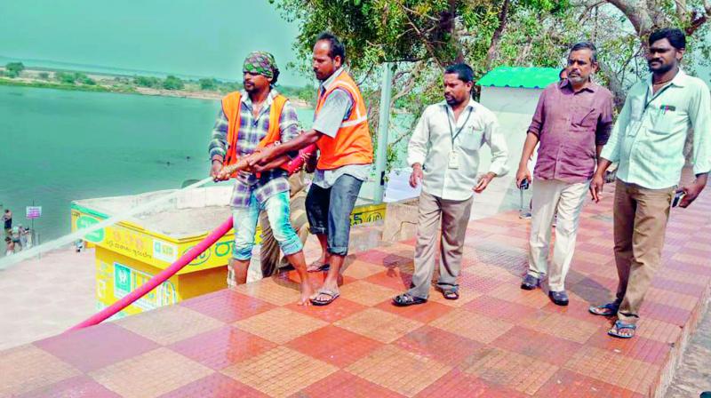 On the even of Mahasivaratri, civic workers clean up the Kotilingala ghat in Rajahmundry on Saturday for devotees. Devotees will throng the ghat to take a holy dip and perform rituals.  (DC)