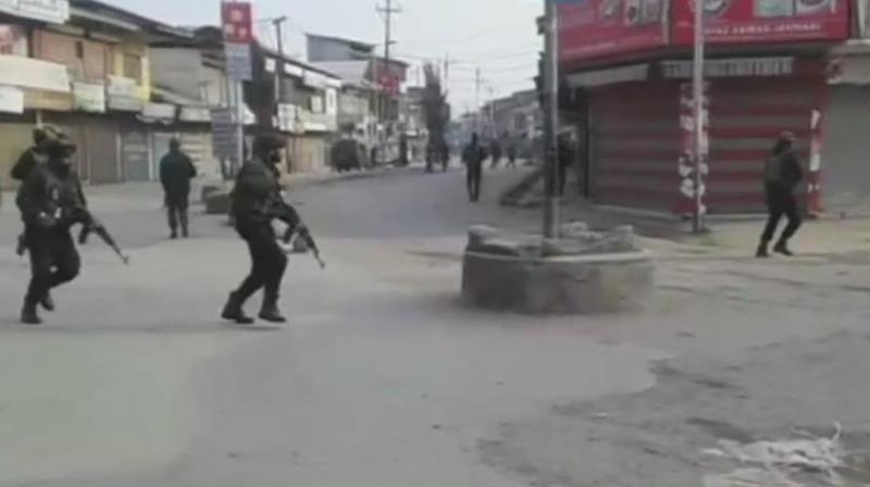 The policemen were patrolling the area in view of a separatist-sponsored strike in Sopore. (Photo: ANI)