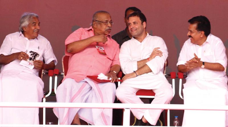 Congress president-elect Rahul Gandhi shares a light moment with RSP general secretary T. J. Chandrachoodan at the launch of the birth centenary campaign of RSP leader Baby John at Thycaud Police Ground in Thiruvananthapuram on Thursday. Opposition Leader Ramesh Chennithala is also seen (Photo:  DC)