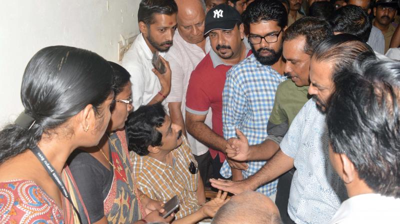 M. K. Muneer, MLA, being surrounded by traders at SM Street in Kozhikode on Friday. (Photo: DC)