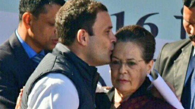 Congress president Rahul Gandhi greets his mother and predecessor Sonia Gandhi after her speech during a grand elevation event held at the lawns of the AICC in New Delhi on Saturday. (Photo: PTI)