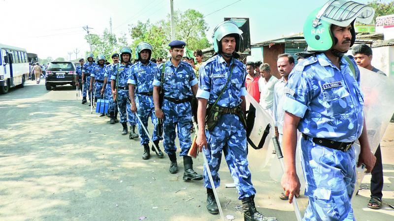 Rapid Action Force personnel patrol at Hasnapur in Utnoor mandal on Saturday after Fridays clashes between Adivasi and Lambada groups. (Photo:  DC