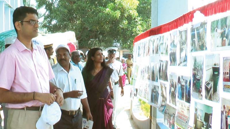 District collector Dr S. Karthikeyan at the photo exhibition organised by the Suchitwa Mission on the collectorate premises on Monday.