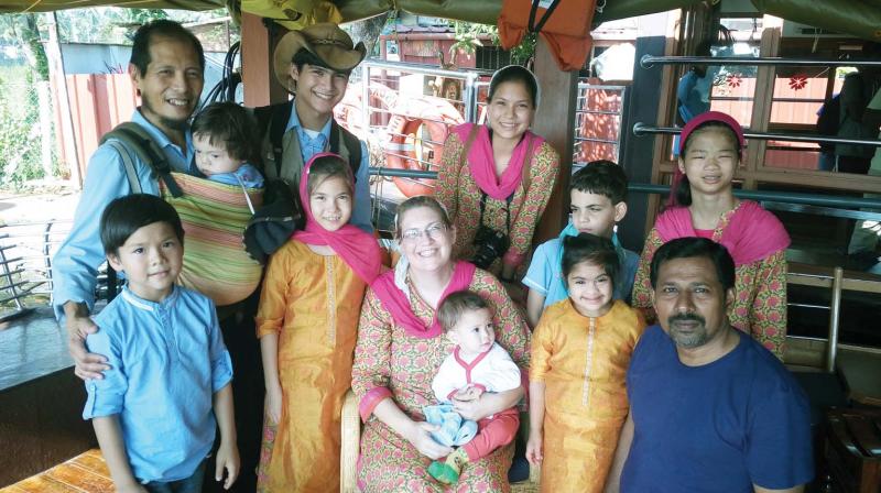 Brent N. Stacey (holding a child) and Jean Inion ( centre) with their kids on board of houseboat on Thursday.